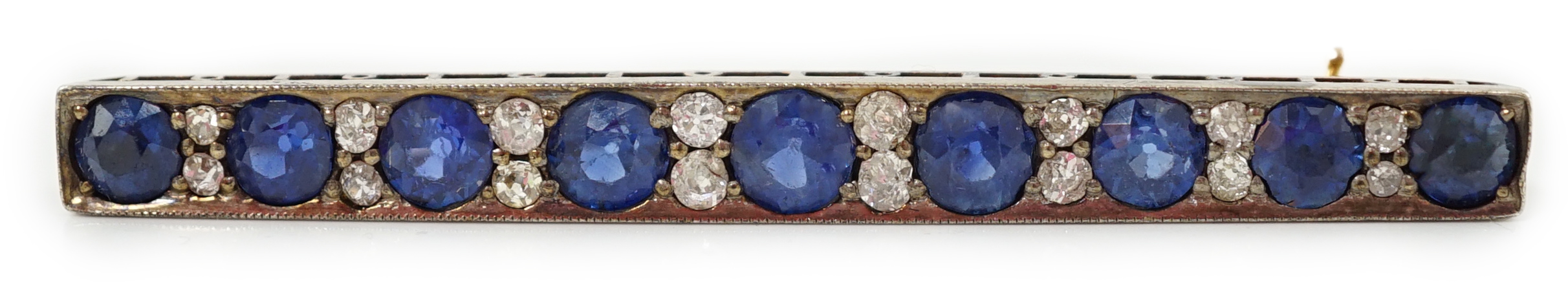 An Edwardian gold and graduated nine stone round cut sapphire set bar brooch